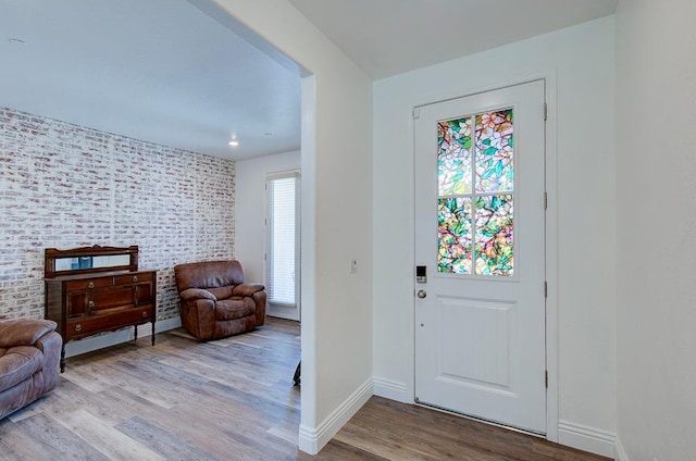foyer entrance with wood finished floors and baseboards