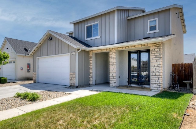 view of front of house with stone siding, concrete driveway, fence, an attached garage, and board and batten siding