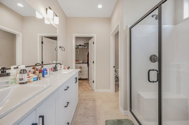 4103 Ash Rd, Madera, CA 93636 - bathroom with tile patterned floors, a sink, a stall shower, double vanity, and toilet