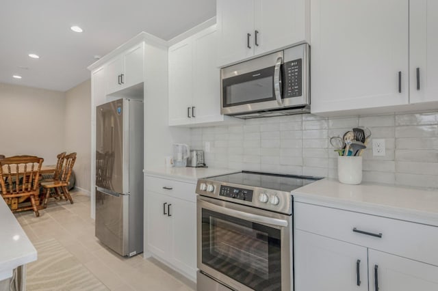 4103 Ash Rd, Madera, CA 93636 - kitchen featuring white cabinets, stainless steel appliances, recessed lighting, decorative backsplash, and light countertops