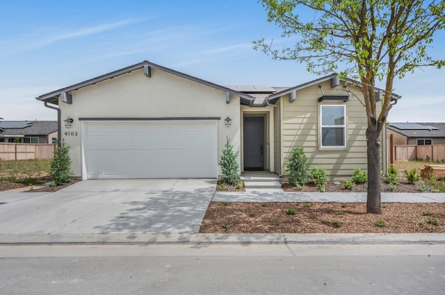 4103 Ash Rd, Madera, CA 93636 - ranch-style home with roof mounted solar panels, concrete driveway, fence, and a garage