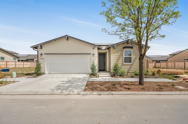 4103 Ash Rd, Madera, CA 93636 - ranch-style house with solar panels, concrete driveway, fence, and a garage