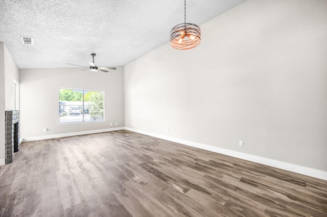 unfurnished living room with wood finished floors, a textured ceiling, ceiling fan, and visible vents