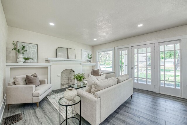 2225 N Van Ness Blvd, Fresno, CA 93704 - living room featuring wood finished floors, a fireplace, recessed lighting, and a textured ceiling