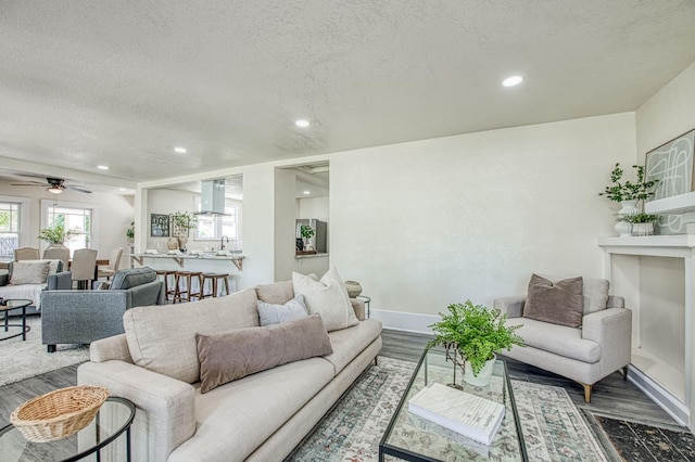 2225 N Van Ness Blvd, Fresno, CA 93704 - living room with a textured ceiling, dark wood-type flooring, recessed lighting, baseboards, and a ceiling fan