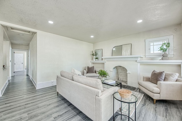 2225 N Van Ness Blvd, Fresno, CA 93704 - living area with wood finished floors, a textured ceiling, baseboards, recessed lighting, and a fireplace