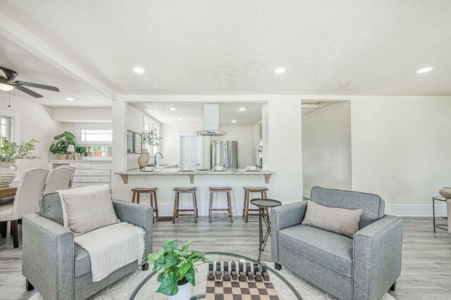 2225 N Van Ness Blvd, Fresno, CA 93704 - living area featuring a ceiling fan, light wood finished floors, recessed lighting, a textured ceiling, and baseboards