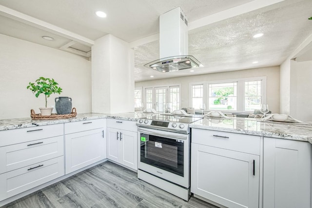 2225 N Van Ness Blvd, Fresno, CA 93704 - kitchen with stainless steel electric range oven, island exhaust hood, recessed lighting, light stone counters, and white cabinets