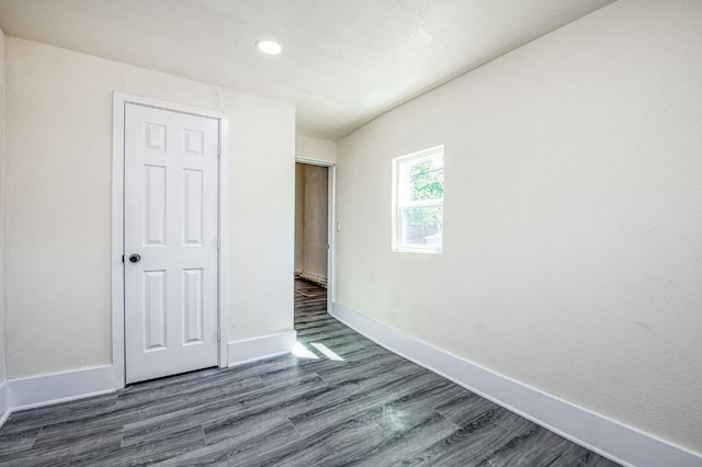 2225 N Van Ness Blvd, Fresno, CA 93704 - unfurnished bedroom with dark wood-style floors, baseboards, and recessed lighting