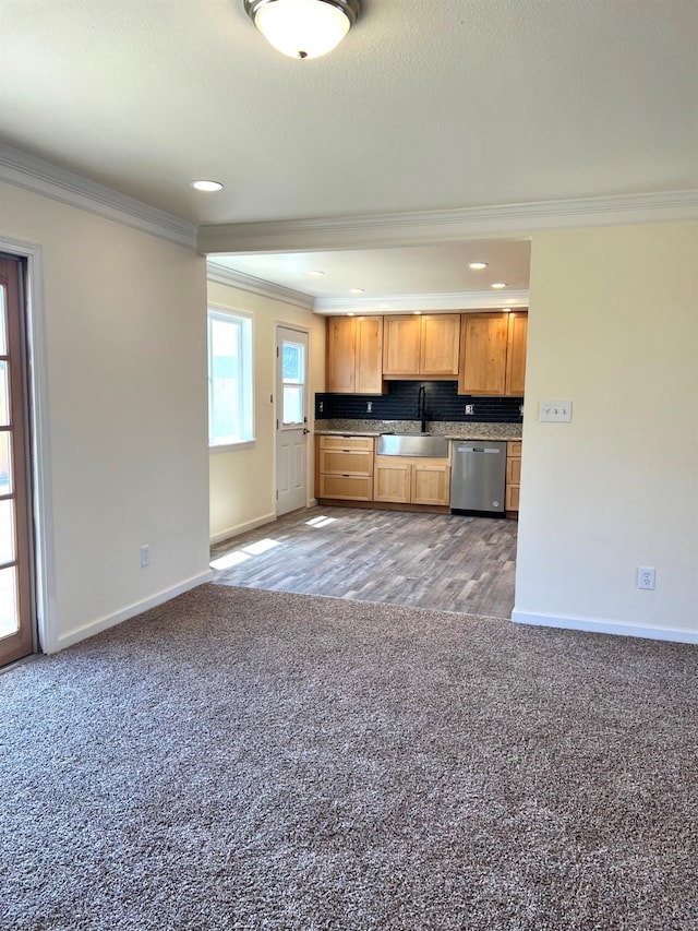 1565 Bluejay, Hanford, CA 93230 - kitchen featuring stainless steel dishwasher, ornamental molding, carpet flooring, a sink, and baseboards
