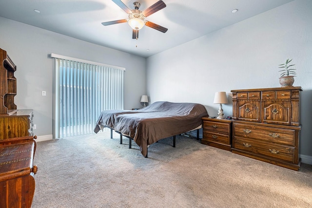 carpeted bedroom with ceiling fan, access to exterior, and baseboards