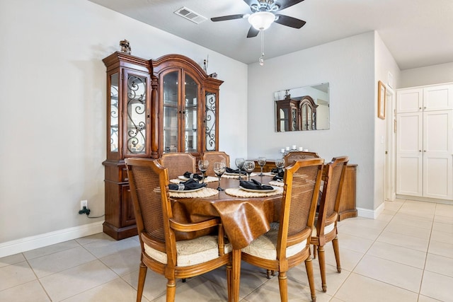 dining space featuring baseboards, visible vents, light tile patterned floors, and ceiling fan