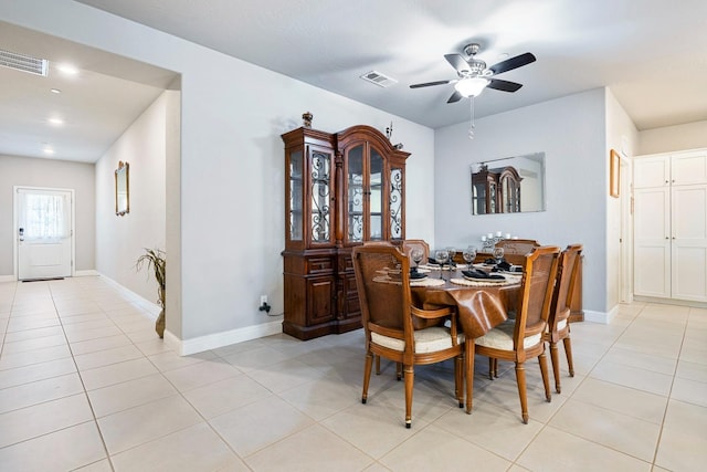 dining room featuring light tile patterned floors, visible vents, a ceiling fan, and baseboards