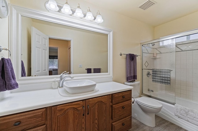 43443 Running Deer Dr, Coarsegold, CA 93614 - full bathroom with shower / bath combination with glass door, visible vents, toilet, wood finished floors, and vanity