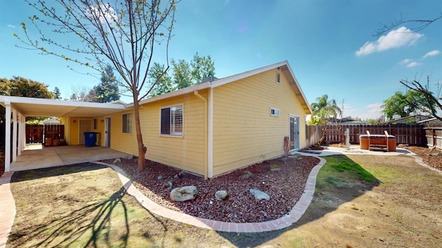 1201 Rayser St, Kingsburg, CA 93631 - view of home's exterior featuring a fenced backyard and a hot tub