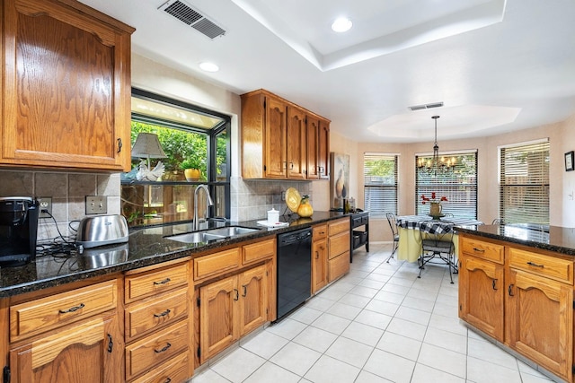kitchen featuring light tile patterned flooring, a sink, a raised ceiling, dishwasher, and visible vents