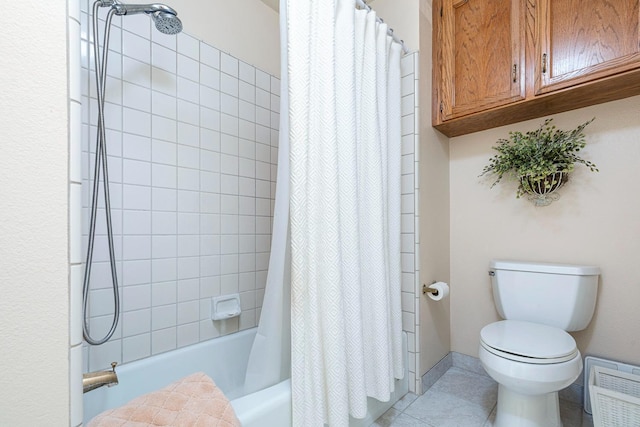 bathroom featuring tile patterned flooring, toilet, and shower / tub combo