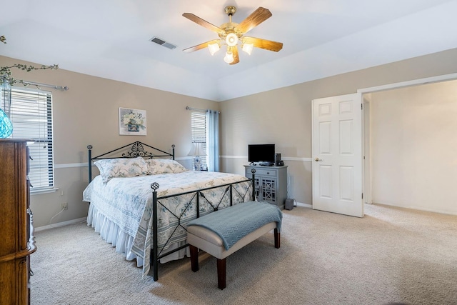 bedroom featuring a ceiling fan, baseboards, visible vents, and light carpet