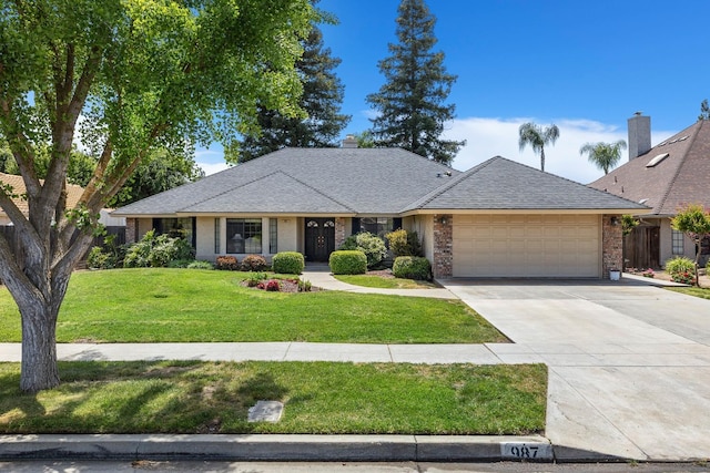 ranch-style house featuring a front yard, brick siding, a shingled roof, concrete driveway, and an attached garage