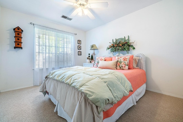 bedroom featuring visible vents, carpet flooring, baseboards, and ceiling fan