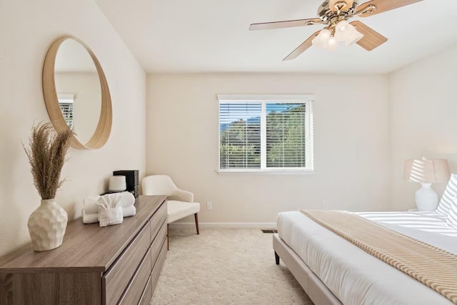 bedroom with baseboards, ceiling fan, and light colored carpet