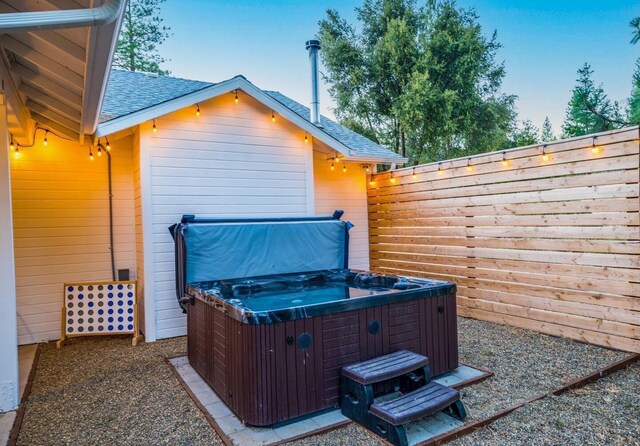 view of patio with fence and a hot tub