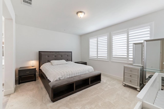 bedroom with visible vents, carpet floors, and baseboards