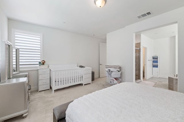 bedroom featuring visible vents and light carpet