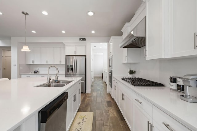 kitchen with light countertops, a sink, stainless steel appliances, and extractor fan