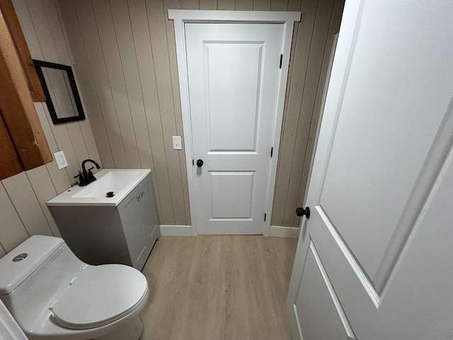 31083 Bear Paw Way, Coarsegold, CA 93614 - bathroom with wood finished floors, wood walls, toilet, vanity, and baseboards