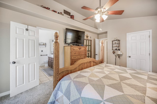 bedroom with light tile patterned floors, a ceiling fan, connected bathroom, and light carpet
