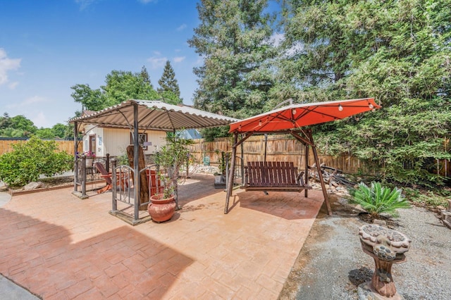 view of patio with a gazebo and a fenced backyard