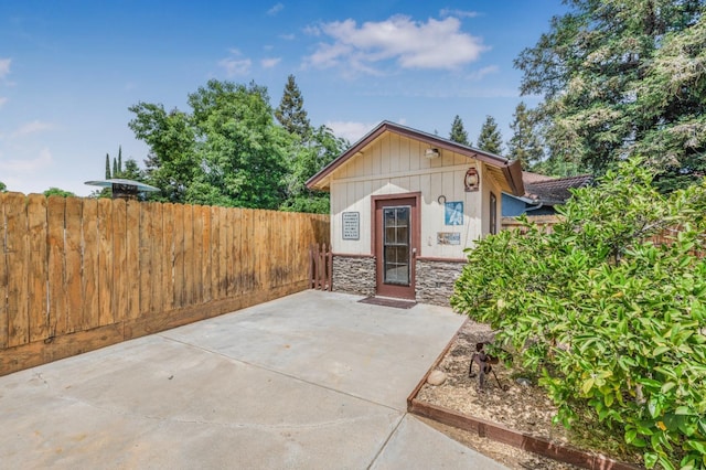 view of outbuilding featuring fence