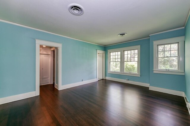 605 E Home Ave, Fresno, CA 93728 - empty room featuring crown molding, baseboards, visible vents, and dark wood-type flooring