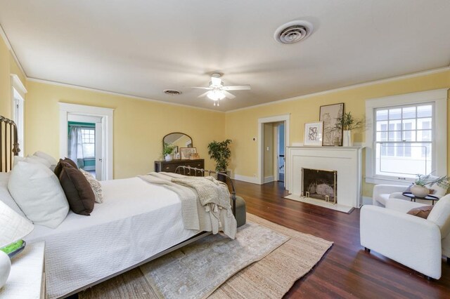 605 E Home Ave, Fresno, CA 93728 - bedroom with visible vents, a fireplace with flush hearth, crown molding, and dark wood-style floors