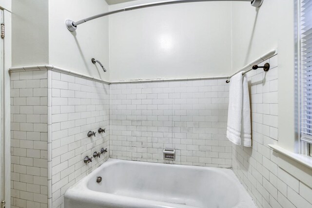 605 E Home Ave, Fresno, CA 93728 - bathroom featuring tile walls and tub / shower combination