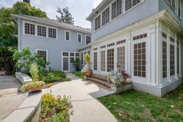 605 E Home Ave, Fresno, CA 93728 - back of property featuring a sunroom, french doors, a patio area, and stucco siding