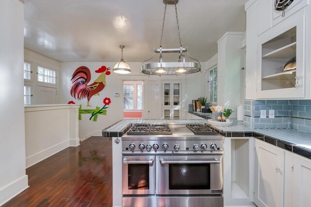 605 E Home Ave, Fresno, CA 93728 - kitchen featuring dark wood-style flooring, baseboards, tile counters, white cabinetry, and double oven range