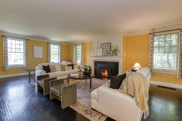 605 E Home Ave, Fresno, CA 93728 - living room featuring visible vents, crown molding, a fireplace, baseboards, and dark wood-style floors