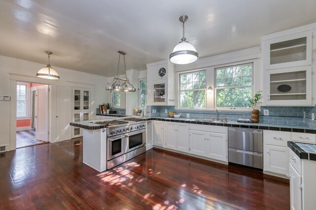 605 E Home Ave, Fresno, CA 93728 - kitchen with a peninsula, tile countertops, white cabinets, dark wood finished floors, and appliances with stainless steel finishes