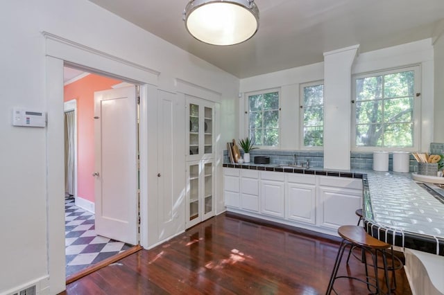 605 E Home Ave, Fresno, CA 93728 - kitchen with a healthy amount of sunlight, tile countertops, white cabinetry, and a sink
