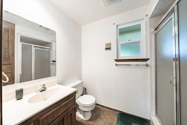 bathroom featuring toilet, vanity, a shower stall, and visible vents