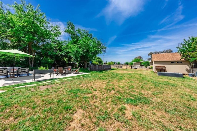 view of yard featuring fence, a patio area, and an outdoor fire pit