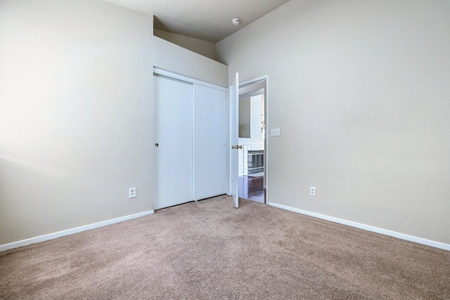 5634 W Donner Ave, Fresno, CA 93722 - unfurnished bedroom featuring a closet, light carpet, and baseboards