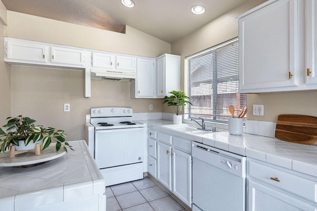 5634 W Donner Ave, Fresno, CA 93722 - kitchen with white appliances, under cabinet range hood, a sink, tile counters, and recessed lighting