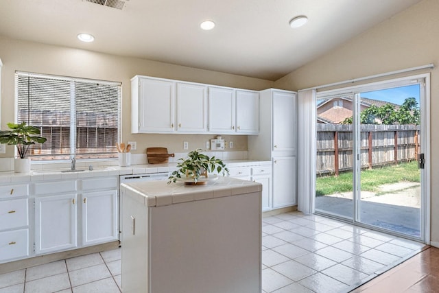 5634 W Donner Ave, Fresno, CA 93722 - kitchen with tile counters, white cabinetry, a sink, light tile patterned flooring, and recessed lighting