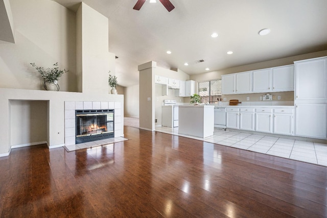 5634 W Donner Ave, Fresno, CA 93722 - unfurnished living room featuring a tile fireplace, a ceiling fan, visible vents, light wood-style flooring, and baseboards