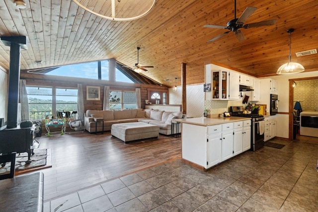 31008 N Dome Dr, Coarsegold, CA 93614 - kitchen with stainless steel gas stove, a ceiling fan, black oven, lofted ceiling, and white cabinets