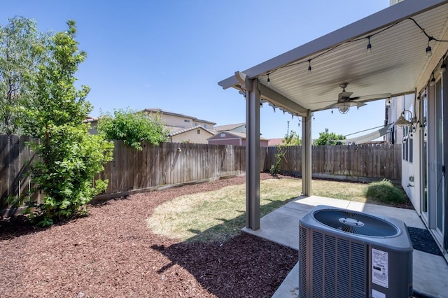 view of yard with ceiling fan, central AC, a fenced backyard, and a patio area