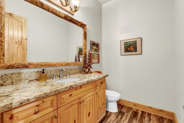 42596 Garnet Ln, Shaver Lake, CA 93664 - half bath with toilet, wood finished floors, vanity, and baseboards